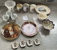 Full view of the 13-piece vintage porcelain set arranged on carpet, showing detail and variety of items including plates, mugs, cups, and decorative dishes.