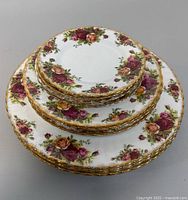 Stacked set of three plate sizes showing pattern and gold trim