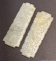Front view of both jade plaques showing carved scroll design