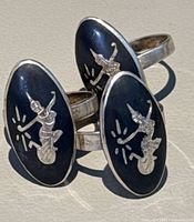 Front view of three Siam Sterling niello rings showing temple dancer design