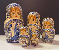 Front view of five nested dolls displaying painted figures