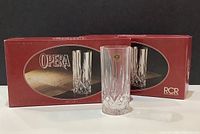 Two red RCR Opera boxes with one glass displayed