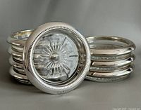 Stack of coasters showing starburst glass and silver rim