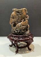 Vase on wooden stand, side view