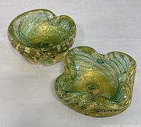 Two Murano glass bowls showing gold flecks and textures