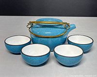 Teapot front with four bowls displayed