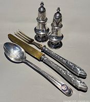 Group shot of both shakers, knife, fork, spoon