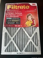 Front view of sealed 3M Filtrete Allergen Defense Allergen Filter box showing branding, size 16x24x1, MPR 1000, filtration level, and image of child with flowers.
