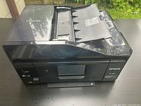 Epson XP-830 wireless all-in-one printer showing the top view with the Auto Document Feeder opened.