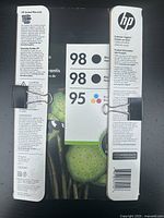 Front and sides of the HP ink cartridge packaging showing warranty, instructions, cartridge numbers 98 (black) and 95 (tri-color).