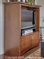 Solid oak entertainment hutch with open TV area, shelf for media components and two sets of double doors for storage below. Upper doors shown detached but included.