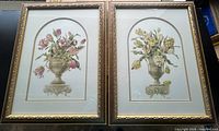Pair of floral art prints in matching ornate gold frames with glass, one print with pink flowers, the other with yellow flowers