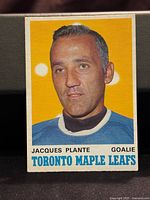 Front of 1970/71 O-Pee-Chee Jacques Plante hockey card showing player portrait with yellow background and text identifying player and team.