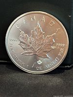 Front side of the silver coin showing the maple leaf design and purity markings.