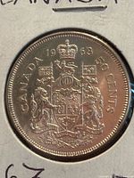 Obverse side of 1963 Canada 50 cents coin showing crowned coat of arms, date 1963, and denomination markings