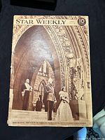Front cover showing British Royalty with ornate stone gothic architecture at Canada House of Commons.