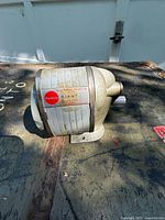 Side view of the vintage Apsco Giant pencil sharpener showing the metal body, crank handle, and brand label.