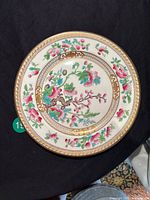 Top-down view of full plate showing overall floral and gold border design