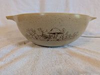 Close-up side view of Pyrex bowl showing mushroom and floral pattern