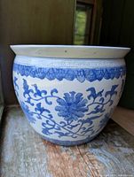 Front view showing blue floral and vine decoration and Greek key pattern on rim.