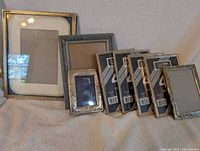 Wide view showing 10 metal picture frames in various sizes and finishes