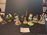 Full lot display showing all 10 assorted porcelain figurines against a dark background with a note reading "Lot 9 Random Porcelain Statues"