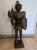 Front view of the 24-inch metal suit of armour statue holding weapon and shield.