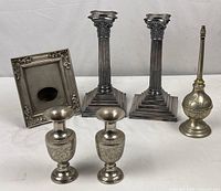 Full group shot showing the two raspberry shaped vases in front, tissue holder on left, two Corinthian column candlesticks in the back, and tall sprinkler on the right.