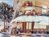 Close-up of the colorful print showing outdoor cafe scene with empty tables, umbrellas, and chairs under awnings with trees on left.