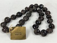 Full view of the kukui nut lei with original tag showing the label.