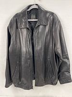 Front view of XXL black leather jacket hanging on a hanger showing full jacket front with collar, zipped open, and pockets visible.