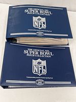Two blue binders with NFL and Super Bowl branding, housing the patch collection