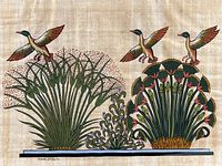 Close-up photo of the papyrus painting showing the two ducks flying over detailed red lotus flowers and foliage, signed at the bottom left.