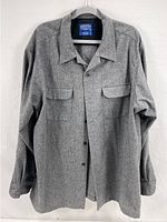 Front view of gray wool board shirt showing the collar, chest pockets, and snap buttons.