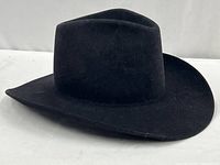 Front angle view of the black felt cowboy hat on white background showing brim and crown details
