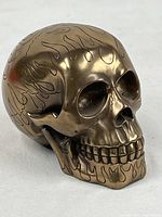 Front-left angle view showing detailed facial features and flame etching on forehead and chin.