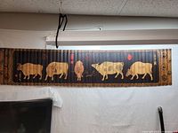 Full view of the wooden panel showing five oxen and decorative borders.