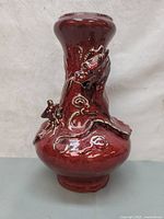 Front view of the Chinese antique oxblood glaze porcelain vase with dragon decoration.