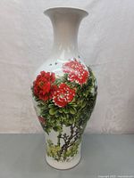 Front view of the tall Chinese porcelain vase showing detailed colorful tree peony flowers and bees.