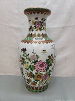 Front view of the vintage Chinese porcelain vase showing floral and butterfly hand-painted designs with gold detailing along the rim and decorative bands.