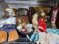 Full lot photo showing all dolls and accessories including cloth and porcelain dolls, doll shoes and clothing.