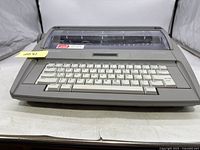 Front view showing the keyboard, roller, and semi-transparent cover of the Brother SX-4000 electronic typewriter.