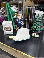 Photo showing the full lot including the ceramic Christmas tree, Penn State Santa, stained glass candle cover, Christmas ornaments including one in box, and the Pfaltzgraff plate smiling dish.