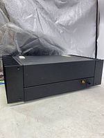 Front view of the black Hafler DH-200 amplifier showing power switch and power indicator light.