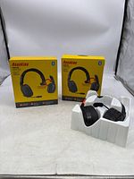 Two yellow boxes of RoadKing RKING4000 headsets with one headset in protective plastic tray visible outside box.