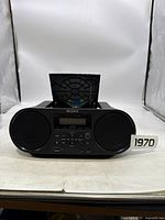 Front view of black Sony mini boombox with CD tray open, showing speakers and control panel