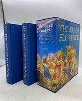 Photo showing two hardcover volumes and decorative slipcase of 'The Art of Florence' set against white background.