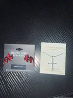 Photo of red glitter Vera Wang dragon earrings in original packaging.