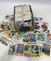 Box filled with hundreds of vintage baseball cards with many displayed including Steve Garvey, Rod Carew, Pete Rose, and others
