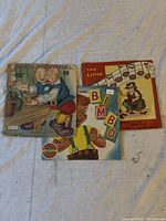 Three vintage children's music vinyl records laid out, showing illustrated covers for Jack and the Beanstalk, Bimbo, and another children's song record